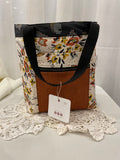 Front view of medium project tote in mustard/black flower