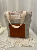 Front view of medium project bag in grey graphic/plants