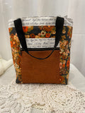 Front view of medium project bag in brown floral/script