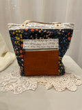 Front view of medium project tote in navy floral/script