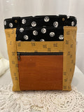 Front view of medium project tote in mustard/black graphic
