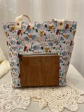 Front view of medium project tote in blue owl