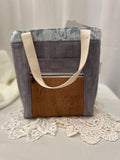 Front view of medium project tote in grey/blue stork